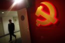 File photo of a trainee walking pass a communist party logo as he attends a training course at the communist party school called China Executive Leadership Academy of Pudong in Shanghai