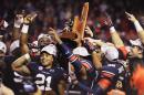 Auburn running back and SEC MVP Tre Mason (21) celebrates with teammates as they hoist the SEC Championship Trophy following the victory over Missouri in the SEC Championship Game at Georgia Dome in Atlanta, Ga. on Saturday Dec. 7, 2013. (AP Photo/Mickey Welsh, Montgomery Advertiser)