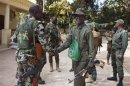 Malian soldiers greet each other in Niono