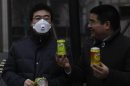 Chen Guangbiao offers a sample of his canned "fresh air" to a passerby in China (Reuters)