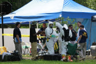 FILE - In this May 31, 2013 file photo, members of an FBI hazardous materials team prepare to enter a residence in New Boston, Texas in connection with a federal investigation surrounding ricin-laced letters mailed to President Barack Obama and New York Mayor Michael Bloomberg. Two U.S. law enforcement officials say Shannon Richardson of New Boston, Texas, has been arrested Friday, June 7, in the investigation. (AP Photo/Texarkana Gazette, Evan Lewis, File) MANDATORY CREDIT