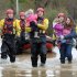 Crew Commander from Tewkesbury fire station Dave Webb carries 19-month-old daughter of Tina Bailey who carries her 3 year old daughter, after they were rescued from their house in Gloucester, England, Tuesday Nov. 27, 2012. Thousands of drivers and residents face further chaos today after heavy rain continued to fall across Britain overnight. (AP Photo/PA, Tim Ireland) UNITED KINGDOM OUT  NO SALES  NO ARCHIVE