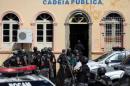 Riot police enter at the public jail in Manaus where some prisoners were relocated after a deadly prison riot in Manaus