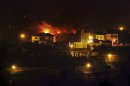 Wildfire advance on residential areas in La Gomera, Spain, Sunday, Aug. 12, 2012. Wildfires spurred by high temperatures raged across Spain's Canary Islands of La Gomera and Tenerife as well as Ourense in northwestern Spain on Saturday, August 11, 2012. Flames are threatening some of Europe's oldest surviving forests in La Gomera and have forced the evacuation of hundreds of people across the country. (AP Photo/Andres Gutierrez)