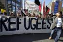 People take part in a solidarity march with migrants and refugees in Brussels, September 27, 2015