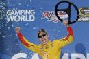 Joey Logano (22) reacts in Victory Lane after winning the NASCAR Sprint Cup Series auto race at Talladega Superspeedway, Sunday, Oct. 25, 2015, in Talladega, Ala. (AP Photo/Butch Dill)