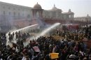 Police use water canons to disperse demonstrators near the presidential palace during a protest rally in New Delhi