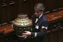 A parliamentary assistant carries a ballot box at the end of the presidential election in the lower house of the parliament in Rome