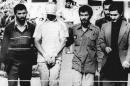 FILE - In this Nov. 9, 1979, file photo, one of the hostages being held at the U.S. Embassy in Tehran is displayed to the crowd, blindfolded and with his hands bound, outside the embassy. Fifty-two of the hostages endured 444 days of captivity. Former Iranian hostages had varied reactions to the news of the nuclear deal between the U.S. and Iran in what is being billed as a trust-building agreement designed to yield a more comprehensive deal six months from now. (AP Photo/File)