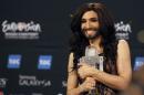 Austrian drag queen Conchita Wurst poses with the trophy after winning the Eurovision Song Contest in Copenhagen