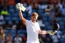 England's batsman Joe Root celebrates scoring his century during day three of the second Test cricket match between the West Indies and England in Saint George's on April 23, 2015