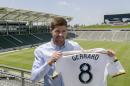 Los Angeles Galaxy new midfielder, Steven Gerrard poses with his new team's jersey after a news conference at StubHub Center in Carson, Calif., on Tuesday, July 7, 2015. The former England captain could play this weekend for the defending MLS champions. (AP Photo/Damian Dovarganes)