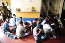 Arrested Sri Lankan men sit inside the police station after authorities cracked down on