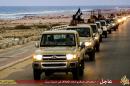 Image made available by Islamist media outlet Welayat Tarablos on February 18, 2015 allegedly shows IS militants parading on a road in the coastal Libyan city of Sirte, 500 kilometres (310 miles) east of the capital, Tripoli