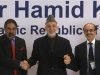 Afghanistan's President Karzai shakes hands with India's TM Sharma and Chairman of the Godrej Group Godrej during a business conference in Mumbai