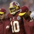 Washington Redskins quarterback Robert Griffin III is helped off the filed after an injury during the second half of an NFL football game against the Baltimore Ravens in Landover, Md., Sunday, Dec. 9, 2012. (AP Photo/Patrick Semansky)