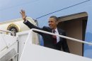 U.S. President Obama waves from the Air Force One at Andrews Air Force Base near Washington