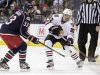 Blackhawks' Oduya clears the puck as Blue Jackets' Aucoin defends during their NHL hockey game in Columbus
