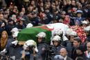 Firemen carry the coffin of late Algerian opposition figure Hocine Ait-Ahmed as people gather to pay their respects, on December 31, 2015 in the capital Algiers