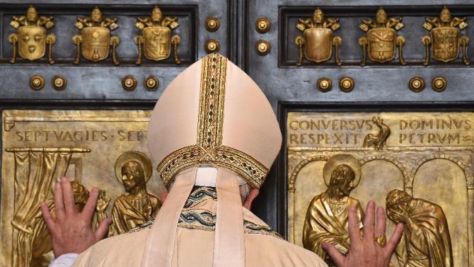 Pope Francis opens a "Holy Door" at St Peter's basilica to mark the start of the Jubilee Year of Mercy at the Vatican, on December 8, 2015