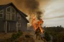 Firefighter works to save a residence as the Butte fire burns in San Andreas, California