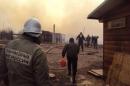 Russian firefighters and local residents extinguish a fire in a village in the region of Khakassia in southeastern Siberia, on April 12, 2015