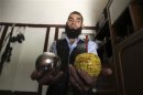 A Free Syrian Army fighter displays homemade bombs made from ornamental balls in the old city of Aleppo