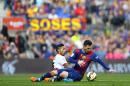 FC Barcelona's Lionel Messi, right, duels for the ball against Rayo Vallecano's Javier Aquino during a Spanish La Liga soccer match at the Camp Nou stadium in Barcelona, Spain, Sunday, March 8, 2015. (AP Photo/Manu Fernandez)