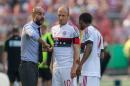 Munich's coach Pep Guardiola, left, addresses Arjen Robben, center, and Douglas Costa de Souza during the German soccer cup first round match between fifth tier team FC Noettingen and Bayern Munich in Karlsruhe, southern Germany, Sunday, Aug. 9, 2015. (AP Photo/Daniel Maurer)