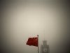 File photo of a Chinese national flag flying in front of Beijing Telegraph Building on a hazy morning in central Beijing