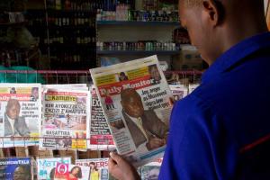 A man reads one of Uganda's local dailies in Kampala …