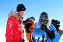 A handout picture from Walking with the Wounded (WWTW) shows Prince Harry (L) and US team member Ivan Castro touching the pole as they reach the South Pole in Antartica on December 13, 2013