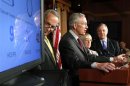 Schumer, Reid, Murray and Durbin stand with a clock counting down to a government shutdown at a news conference at the U.S. Capitol in Washington