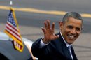 President Barack Obama waves to the crowd as he arrives at Phoenix Sky Harbor International Airport in Phoenix, Tuesday, Aug. 6, 2013, on his way to give a speech on housing and the middle class. (AP Photo/Ross D. Franklin)