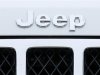 Logo on the front of a Jeep vehicle is shown at Chrysler dealership in Carlsbad, California