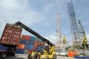 A crane tries to load a container on a truck at the Port of Takoradi, Ghana, on December 4, 2008