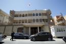 Man walks past the South Korean embassy after it was attacked by gunmen in Tripoli