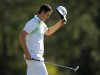 Justin Rose of England tips his hat after sinking a birdie putt on the 18th green during second round play in the 2013 Masters golf tournament in Augusta