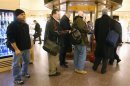 People line up to buy Powerball tickets from a newsstand inside Grand Central Station in New York