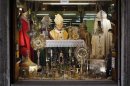 A Pope John Paul II statue is displayed in a tailor shop window in Rome