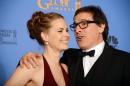 Amy Adams, left, and David O. Russell, winners of the award for best motion picture - comedy or musical for "American Hustle" pose in the press room at the 71st annual Golden Globe Awards at the Beverly Hilton Hotel on Sunday, Jan. 12, 2014, in Beverly Hills, Calif. (Photo by Jordan Strauss/Invision/AP)