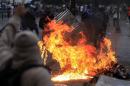 Anti-government protesters erect a fiery barricade during clashes with police at Altamira square in Caracas