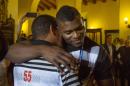 Los Angeles Dodgers outfielder Yasiel Puig, right, hugs his former coach Juan Arechavaleta as he arrives to Hotel Nacional in Havana, Cuba, Tuesday, Dec. 15, 2015. A lineup of Cuban baseball superstars including some of the most famous defectors in recent memory made a triumphant return Tuesday as part of the first Major League Baseball trip to the island since 1999. "I'm very happy to be here," said Puig, who had been barred from returning to Cuba until he was granted special permission for this week's trip. (AP Photo/Desmond Boylan)