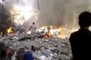 This image made from citizen journalist video posted by the Shaam News Network, which is consistent with other AP reporting, shows the aftermath of a car bomb attack on a market in the town of Darkoush in Idlib province, Monday, Oct. 14, 2013. Syrian activist groups say the bombing in a rebel-held northwestern town has killed and wounded dozens of people. Car bombs are becoming more common in Syria's civil war, now in its third year. The conflict has killed more than 100,000 people.(AP Photo/Shaam News Network via AP video)