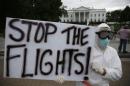 Protestor Hulbert of Annapolis holds a sign reading "Stop the Flights" as he demonstrates in favor of a travel ban to stop the spread of the Ebola virus, in front of the White House in Washington