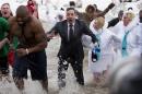 "The Tonight Show" host Jimmy Fallon, center, exits the water during the Chicago Polar Plunge, Sunday, March 2, 2014, in Chicago. Fallon joined Chicago Mayor Rahm Emanuel in the event. (AP Photo/Andrew A. Nelles)