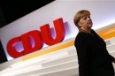 German Chancellor and leader of CDU Merkel walks up to podium during the CDU's annual party meeting in Hanover