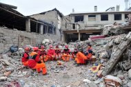 Turkish rescue workers rest during an operation to salvage people from a collapsed building after an earthquake in the Ercis, province of Van, in eastern Turkey. The 7.2-magnitude earthquake killed 366 people and injured some 1,300, the emergency unit of the prime minister's office has said