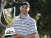 John Merrick holds the trophy after his victory in the Northern Trust Open golf tournament at Riviera Country Club in the Pacific Palisades area of Los Angeles, Sunday, Feb. 17, 2013. (AP Photo/Reed Saxon)