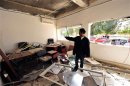 A policeman stands inside an office of a police station after a bomb explosion in Benghazi